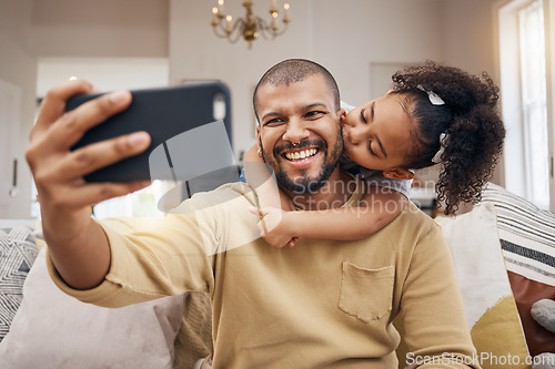 Image of Father, girl and selfie kiss in home living room, bonding and having fun together. Dad, child and hug in profile picture, happy memory and smile on social media post of family on sofa, love and care