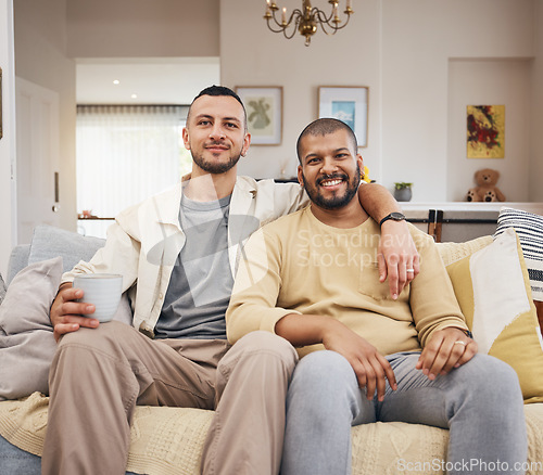Image of Happy, smile and portrait of a gay couple on a sofa relaxing with a cup of coffee in the living room. Love, bonding and young lgbtq men with a latte sitting together in the lounge at their home.