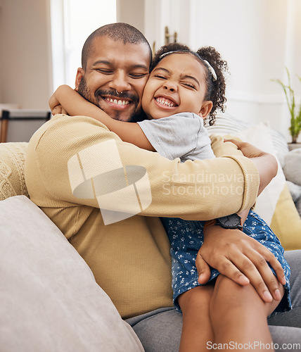 Image of Happy, love and girl hugging her father while relaxing on a sofa in the living room together. Smile, care and child bonding, embracing and sitting with her young dad in the lounge of their home.