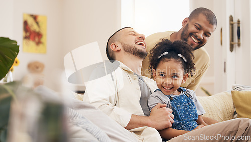 Image of Gay family, laughing and a child on a home sofa with love, care and funny joke in lounge. Lgbtq men, adoption and parents with foster girl kid together on a couch for happiness, bonding and to relax