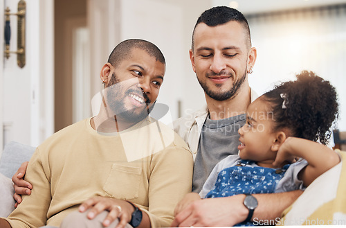 Image of Child, gay family and happy on a sofa at home with love, care and safety in a lounge. Lgbtq men, interracial and adoption with foster girl kid together on a couch for happiness, bonding and to relax
