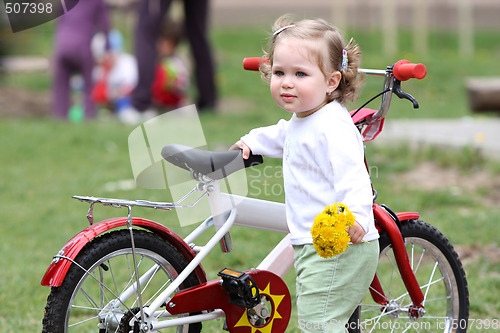 Image of girl with flower and bicycle