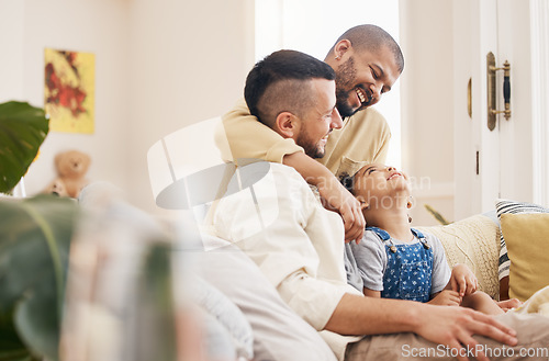 Image of Gay, happy family and a child hug on a home sofa with love, care and safety in a lounge. Lgbtq men, adoption and parents with a foster girl kid together on a couch for happiness, bonding and to relax