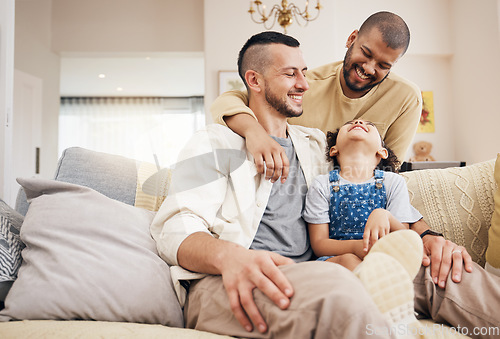 Image of Gay family, child and happy on a home sofa with love, care and safety in a lounge. Lgbtq men, adoption and interracial parents with a girl kid together on a couch for happiness, bonding and relax