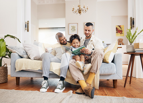 Image of Gay parents on a couch, girl and reading book with a smile, home and education with bonding, relax and weekend break. Fathers, female child and kid with lgbtq, storytelling and fairytale in a lounge