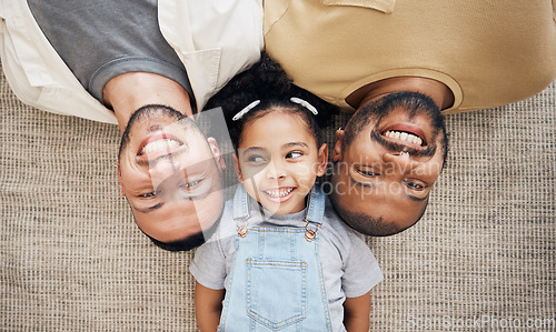 Image of Gay dad, blended family and adoption with a girl lying together on the floor of the home for love from above. LGBT smile, children or kids and a daughter bonding with her happy parents in the house