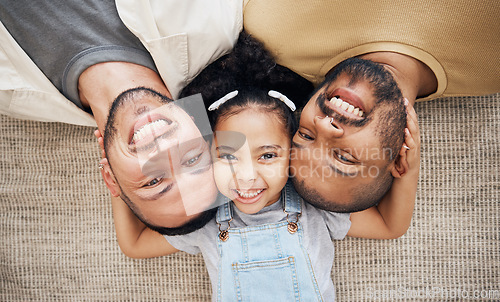 Image of Portrait, gay dad and blended family with a girl lying together on the floor of the home for adoption from above. LGBT love, children or kids and a daughter with her happy foster parents in the house