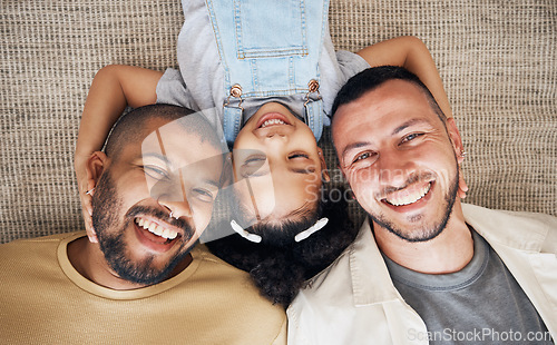 Image of Gay dad, blended family and foster with a girl lying together on the floor of the home for adoption from above. LGBT love, children or kids and a daughter bonding with her happy parents in the house