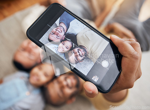 Image of Selfie, gay dad and blended family with a girl lying together on the floor of the home for a photograph from above. LGBT love, children or kids and a daughter with her happy parents taking a picture