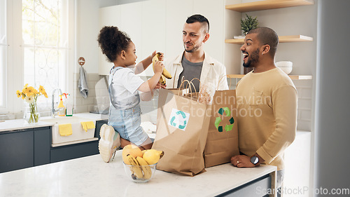 Image of Recycling, blended family or adoption with a girl and gay couple in the home kitchen for sustainability. LGBT, eco friendly or waste with a daughter and parents unpacking bananas from a grocery bag