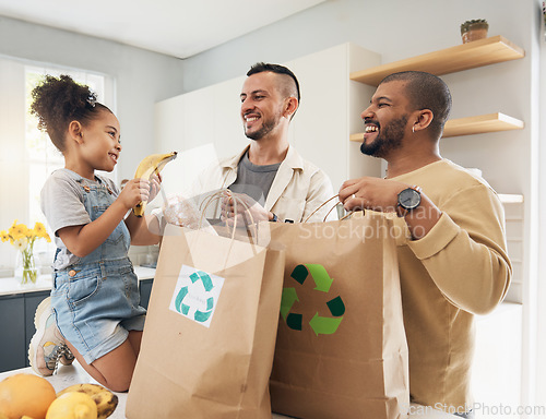 Image of Shopping, bags and happy family with groceries in home and girl with fruit and gay parents, dad and father in kitchen. Sustainable, paper bag and people with eco friendly grocery, product or fruits