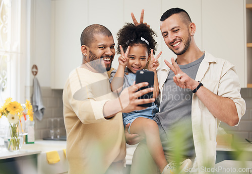 Image of Selfie, blended family and a happy girl with her gay parents in the kitchen together for a profile picture. Adoption photograph, smile or love and a playful daughter with her lgbt father in the home