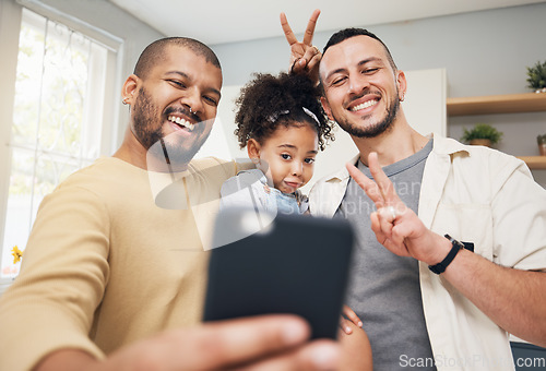 Image of Selfie, blended family and a happy girl with her lgbt parents in the kitchen together for a profile picture. Adoption photograph, smile or love and a playful daughter with her gay father in the home