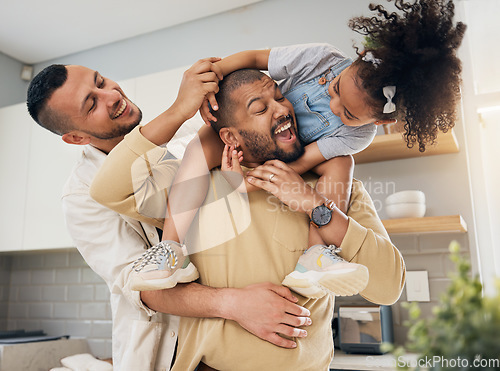 Image of Gay, happy family and playing with child in home or parents together with love, support and girl on shoulders of dad. LGBT, fathers and men with happiness, smile and fun bonding in kitchen with kid