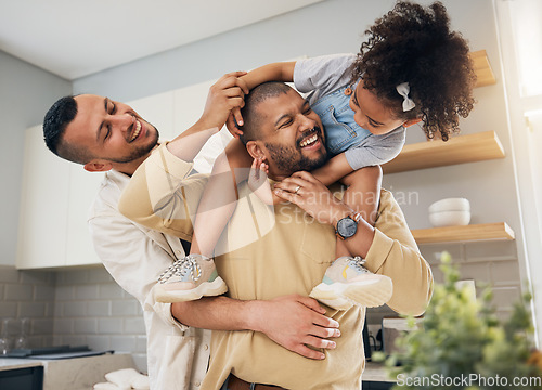 Image of Happy family, gay parents and playing with child in home together with love, support and bonding with girl on shoulders LGBT, fathers and men with happiness, smile and dads in kitchen with kid