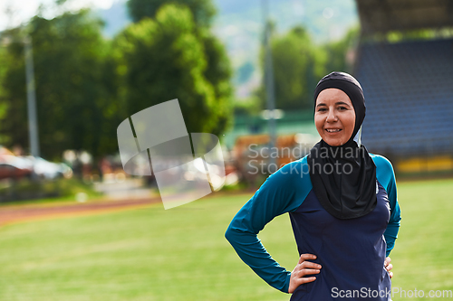 Image of A Muslim woman with a burqa, an Islamic sportswoman resting after a vigorous training session on the marathon course. A hijab woman is preparing for a marathon competition