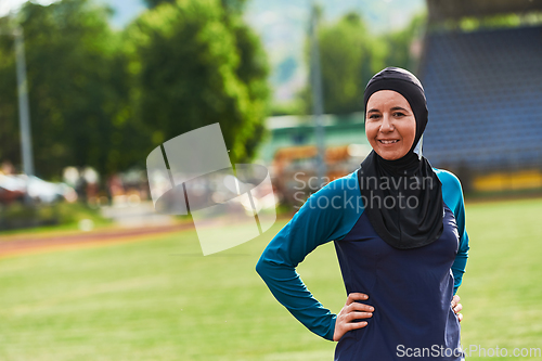 Image of A Muslim woman with a burqa, an Islamic sportswoman resting after a vigorous training session on the marathon course. A hijab woman is preparing for a marathon competition