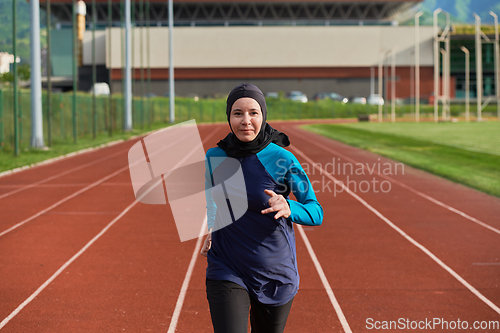 Image of A muslim woman in a burqa sports muslim clothes running on a marathon course and preparing for upcoming competitions