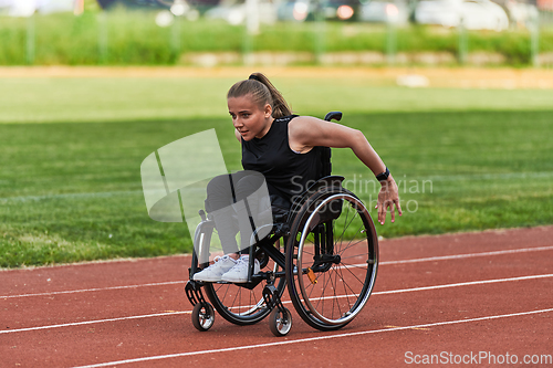 Image of A woman with disablity driving a wheelchair on a track while preparing for the Paralympic Games