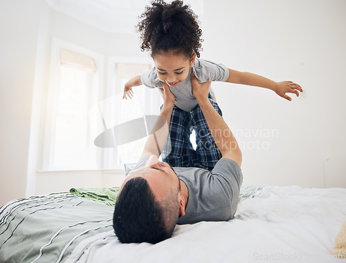 Image of Happy, fun and dad with child on bed playing, bonding and airplane game for father and daughter in home. Family, love and playful energy, man holding girl in air and laughing in bedroom together.