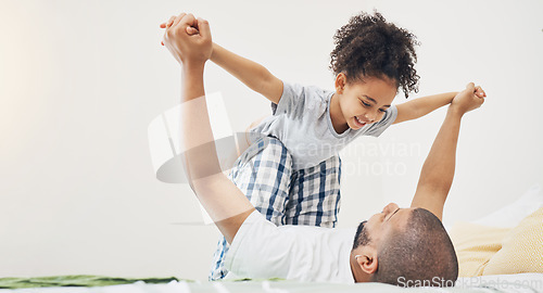 Image of Home, father and daughter on a bed for airplane game, bonding and happiness in morning. Excited girl child and man or parent together in a family bedroom for fun, playing and support for lift in air