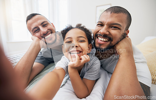 Image of Gay, family and selfie portrait of child in home bedroom, bonding and fun together. Face of men, lgbtq parents and girl on bed in adoption, foster and profile picture, happy memory and interracial