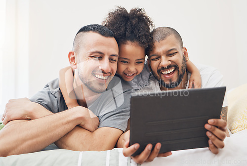 Image of Tablet, gay family and child on a bed at home for e learning, watch video and education on internet. Adoption, lgbt men or parents with a happy kid and technology for streaming movies, games or app