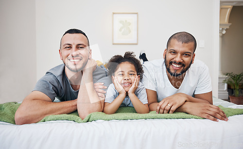 Image of Gay, happy family and a child on a bed at home with love, care and safety in a bedroom. Lgbtq men, adoption and interracial parents with foster girl kid together in morning with a smile and happiness