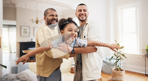 Image of Gay parents, girl and playing as airplane in home or holding kid as a plane, lifting or flying in living room for fun bonding game. LGBT, father and dad support child together in the air or lounge