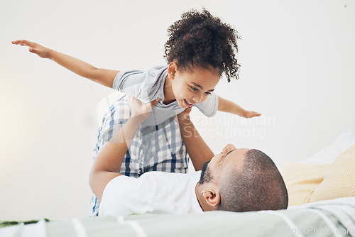 Image of Happy, fun and father with girl on bed playing, bonding and airplane game for dad with child in home. Family, love and playful energy, man holding daughter in air and laughing in bedroom together.