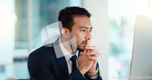 Image of Stressed web developer suffering with mental block while trying to code on a computer in his office. Frustrated data scientist struggling with fatigue and feeling the pressure to hit his deadline