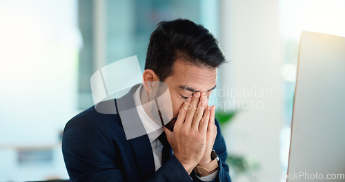 Image of Stressed web developer suffering with mental block while trying to code on a computer in his office. Frustrated data scientist struggling with fatigue and feeling the pressure to hit his deadline