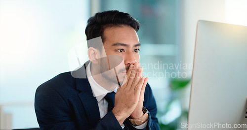 Image of Stressed web developer suffering with mental block while trying to code on a computer in his office. Frustrated data scientist struggling with fatigue and feeling the pressure to hit his deadline