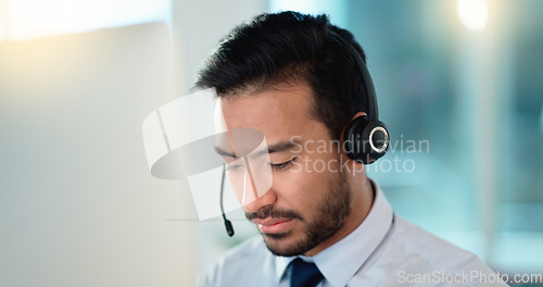 Image of Call center agent talking and listening to a client on a headset while working in an office. Confident and reassuring salesman consulting and operating a helpdesk for customer service and support