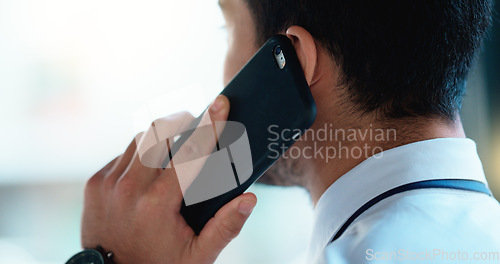 Image of Business man talking on a phone call in an office. Closeup of corporate professional and entrepreneur from the back networking to build a successful empire. Communicating plans and deals with clients