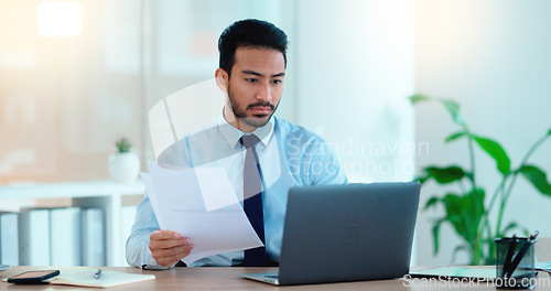 Image of Young man working on his laptop in an office frustrated, stressed and angry about a bad sales report after a marketing campaign. Business manager upset and annoyed that he didnt hit his deadline