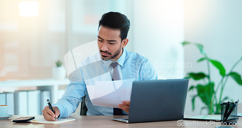 Image of Lawyer and attorney working on corporate plans and compiling legal reports for a case at his desk. Business man and project manager reading and writing notes while working on a laptop in an office