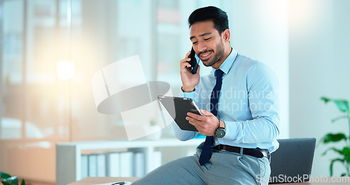 Image of Business man talking on a phone while browsing on a digital tablet in an office. Dedicated sales executive and young expert communicating project plans and discussing deals with clients in a company