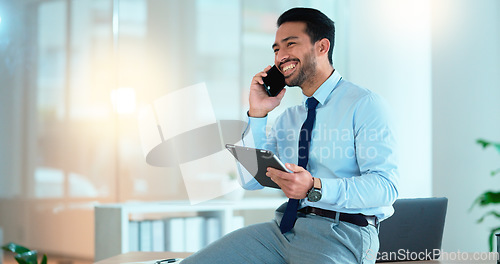 Image of Business man talking on a phone while browsing on a digital tablet in an office. Dedicated sales executive and young expert communicating project plans and discussing deals with clients in a company