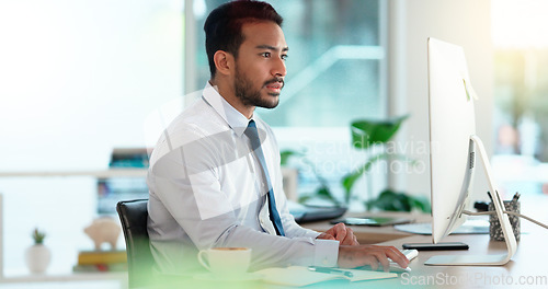 Image of Busy male Accountant typing an email in a modern office. A financial advisor compiling a finance proposal for a successful company. A serious Auditor writing a business investment report