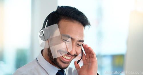 Image of Call center agent consulting a buyer via video call in an office. A young friendly sales man talking to a client in a virtual meeting. A male customer service employee advising a consumer