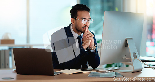 Image of Business man analyzing a project strategy on a computer screen while working in an office. Serious and focused corporate professional thinking of solutions while considering ideas, choices and plans