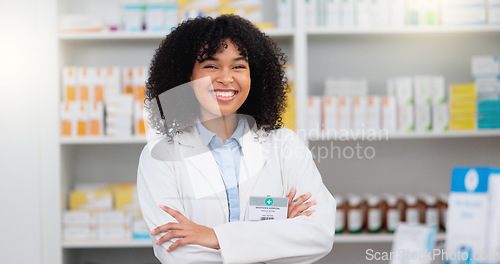 Image of Portrait of a pharmacist with folded arms against a background of prescription medication. Happy young professional health care worker waiting to diagnose and prescribe pills at a clinic dispensary