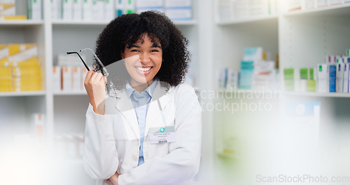 Image of A friendly female pharmacist with a bright smile is about to help patients at the dispensary. Portrait of happy woman healthcare professional smiling at the pharmacy. A doctor taking off her glasses