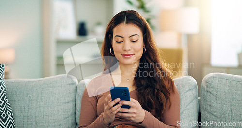 Image of Phone, social media and happy woman texting on a dating app and smiling on the weekend at home on the couch. Smile, chatting and young girl loves typing a message on a social networking website