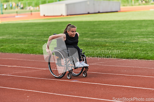 Image of A woman with disablity driving a wheelchair on a track while preparing for the Paralympic Games