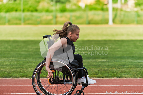 Image of A woman with disablity driving a wheelchair on a track while preparing for the Paralympic Games