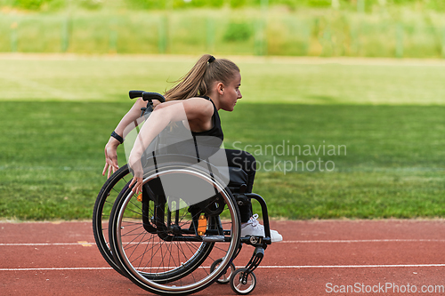 Image of A woman with disablity driving a wheelchair on a track while preparing for the Paralympic Games