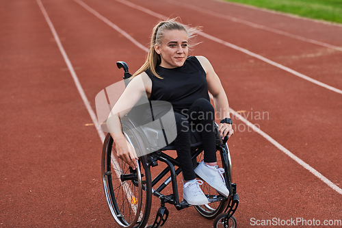 Image of A woman with disablity driving a wheelchair on a track while preparing for the Paralympic Games