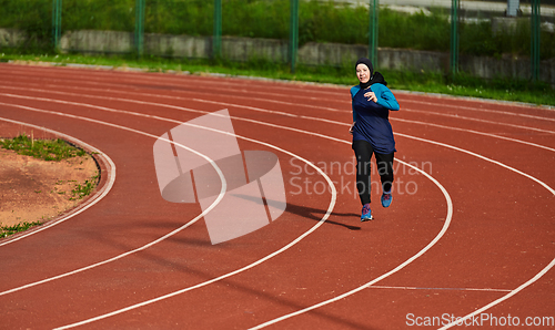 Image of A muslim woman in a burqa sports muslim clothes running on a marathon course and preparing for upcoming competitions